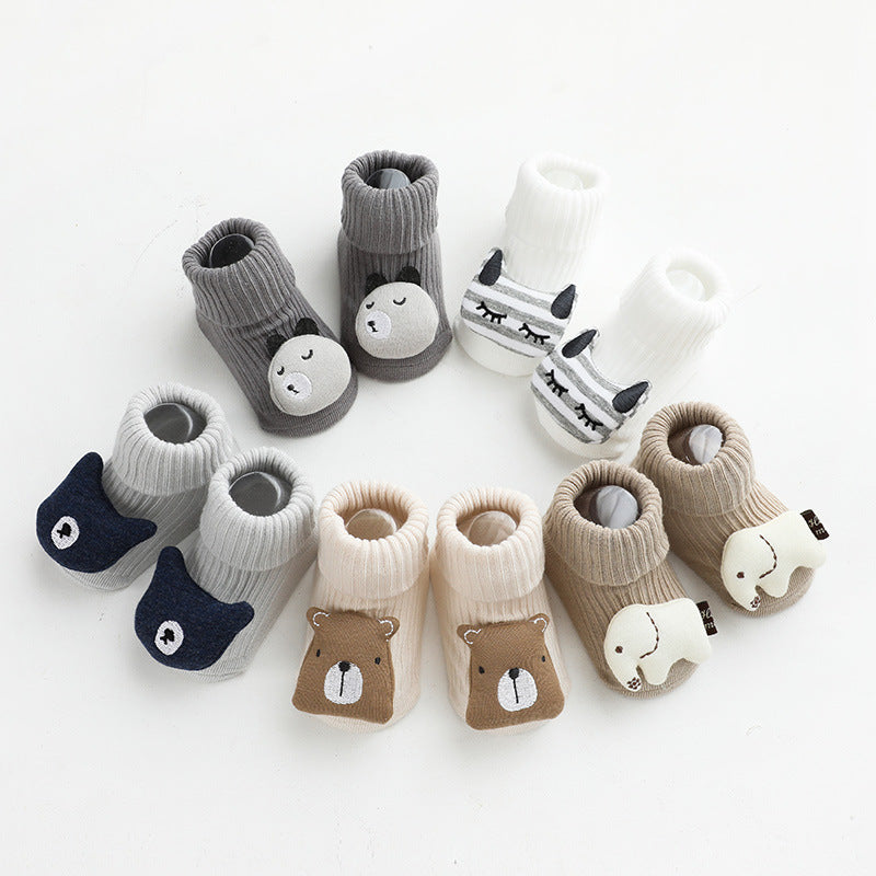 Animal-themed baby socks in cream, gray, and beige